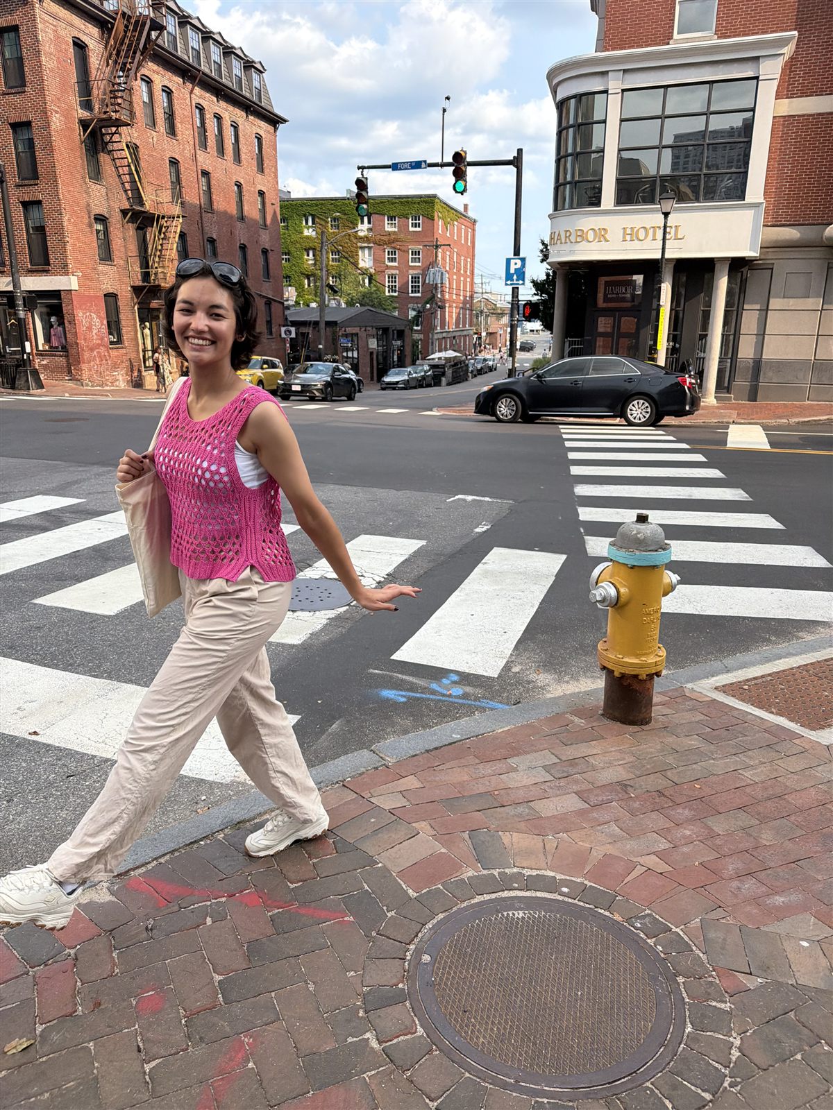 Laura Park smiling on a city street corner